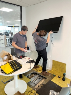 AV technicians fitting large display screen at BCS Swindon.