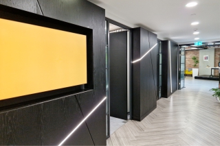 Large display screens showing art at BCS London.