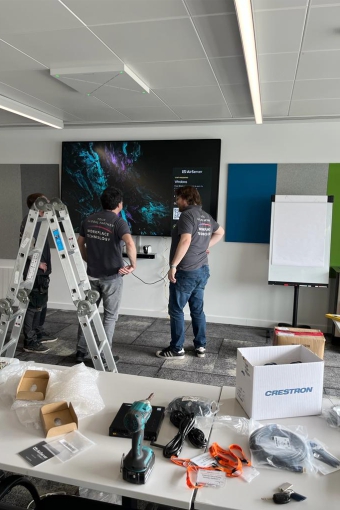 Installing screens in one of Bristol airport training rooms