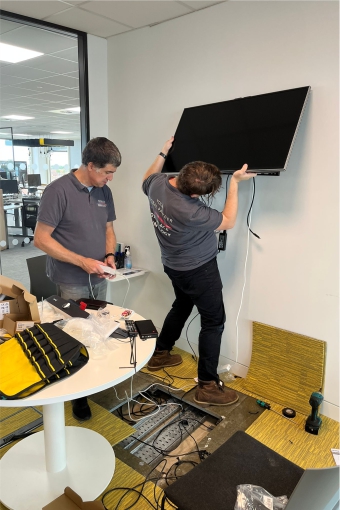 Technicians installing audiovisual technology at BCS Swindon