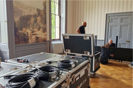 Unpacking a large video wall in the ball room at Hartham Park.