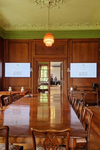 a view of two digital screen displays in the Library at Hartham Park.