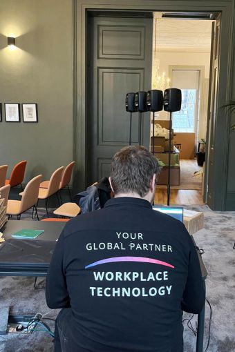 VCW engineer setting up Genelec speakers in BVA London Mary Brancker room.