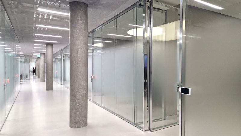 Oakley hallway with glass walled meeting rooms Oakley hallway with glass walled meeting rooms