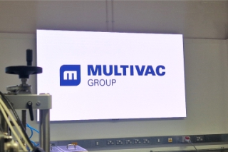Large bright LED screen at Multivac Innovation centre showing company logo